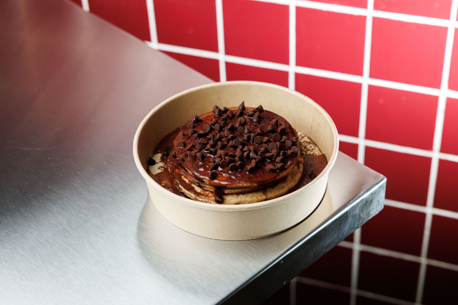 Choco Chip Protein Pancakes — vanilla protein, oat flour, light pancake syrup, chocolate chips, cacao dusting.