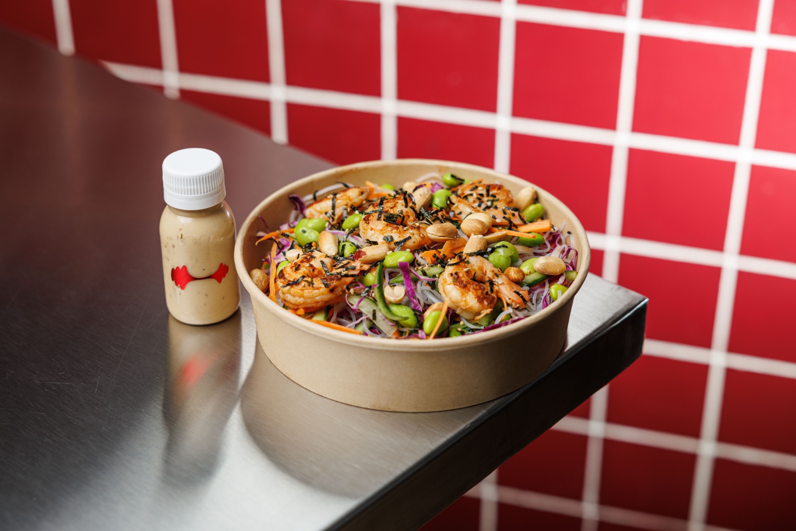 Tokyo Salad — red cabbage, carrot, cucumber, edamame, rice noodles, seared shrimp, toasted peanuts,
furikake, Asian dressing