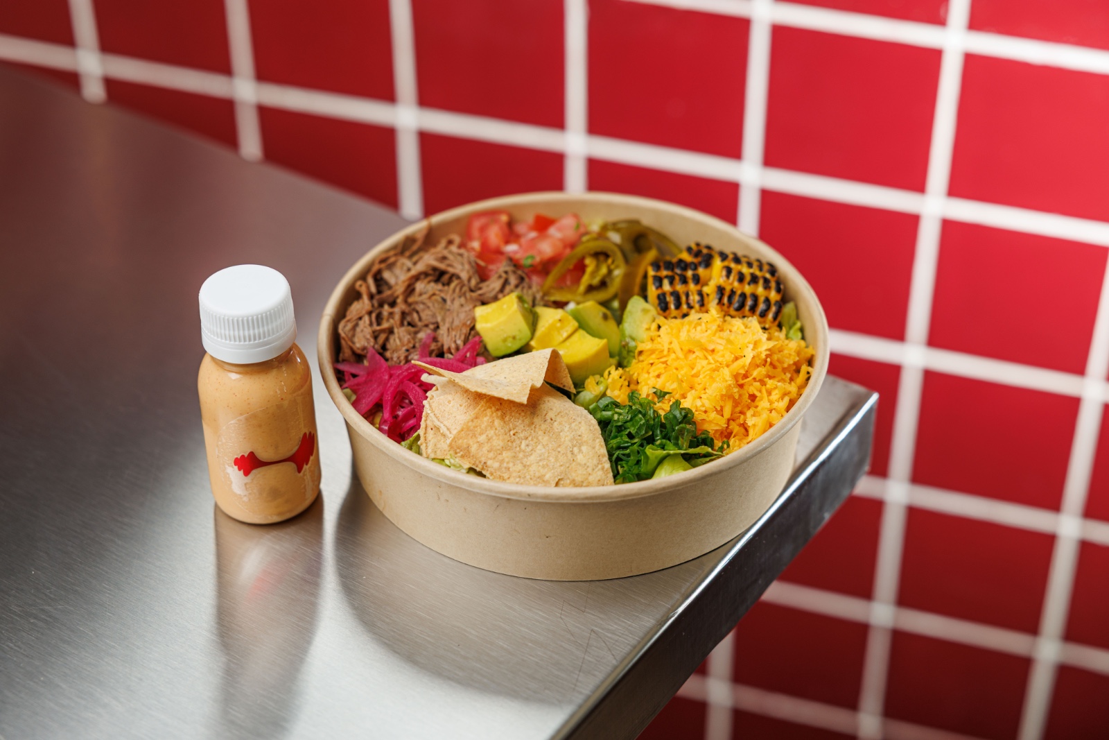 Chipotle Bar Beef — shredded beef, iceberg lettuce, green onion, pickled onion, avocado, pico de Gallo, charred corn, jalapenos, cheddear, c...