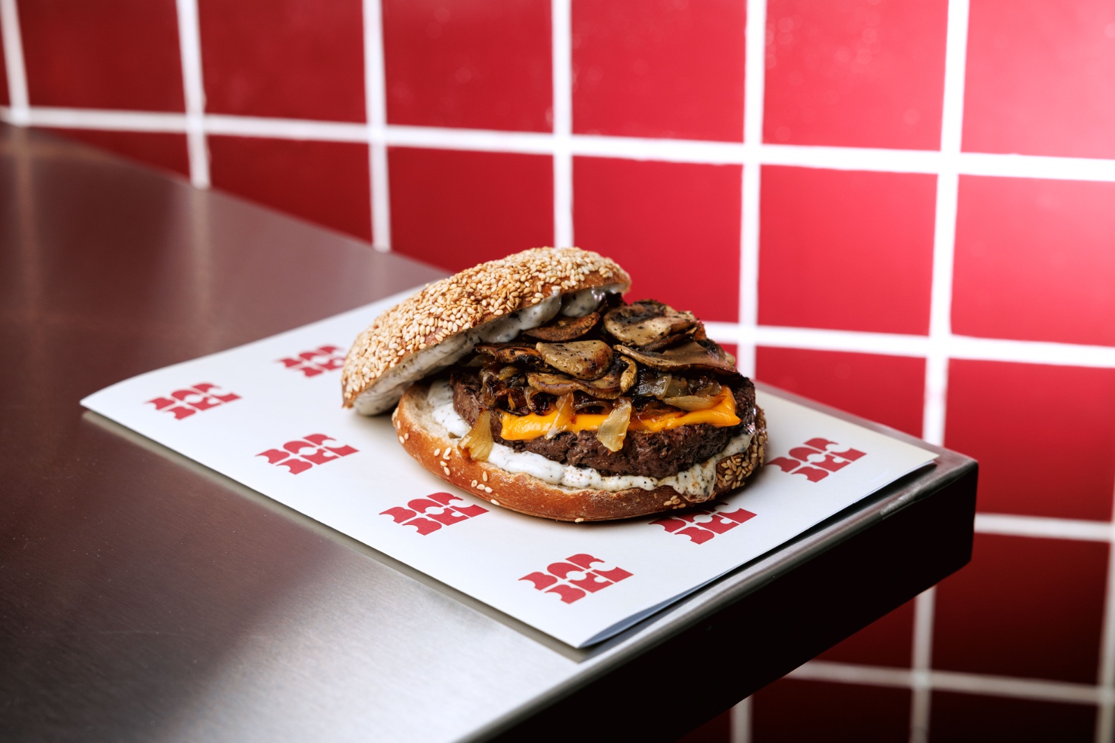 Truff Bagel Burger — beef patty, cheddar cheese, seared mushrooms, caramelized onion, light truffle mayo.