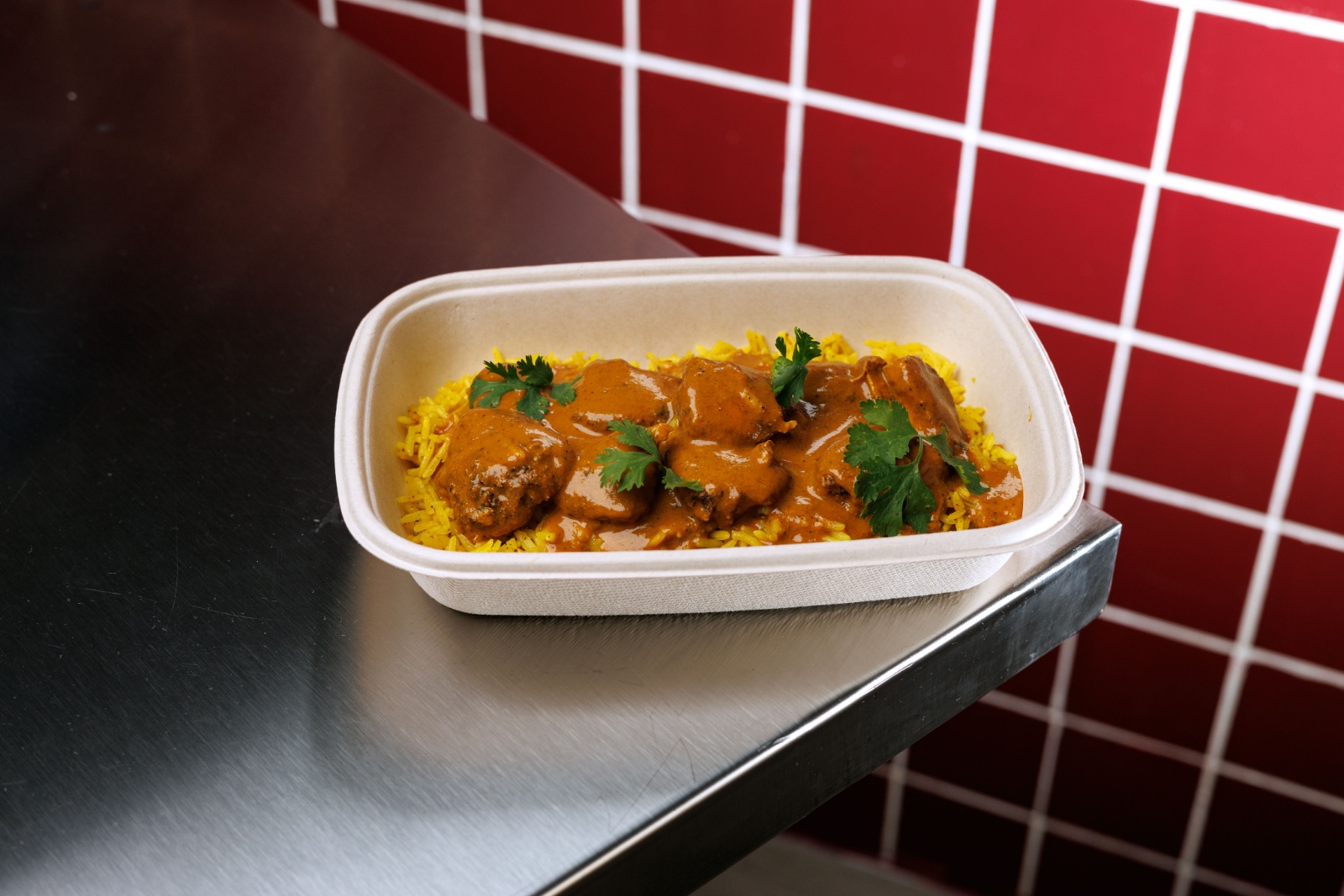 Light Butter Chicken — marinated grilled Indian chicken cubes, light cashew butter sauce, steamed turmeric rice