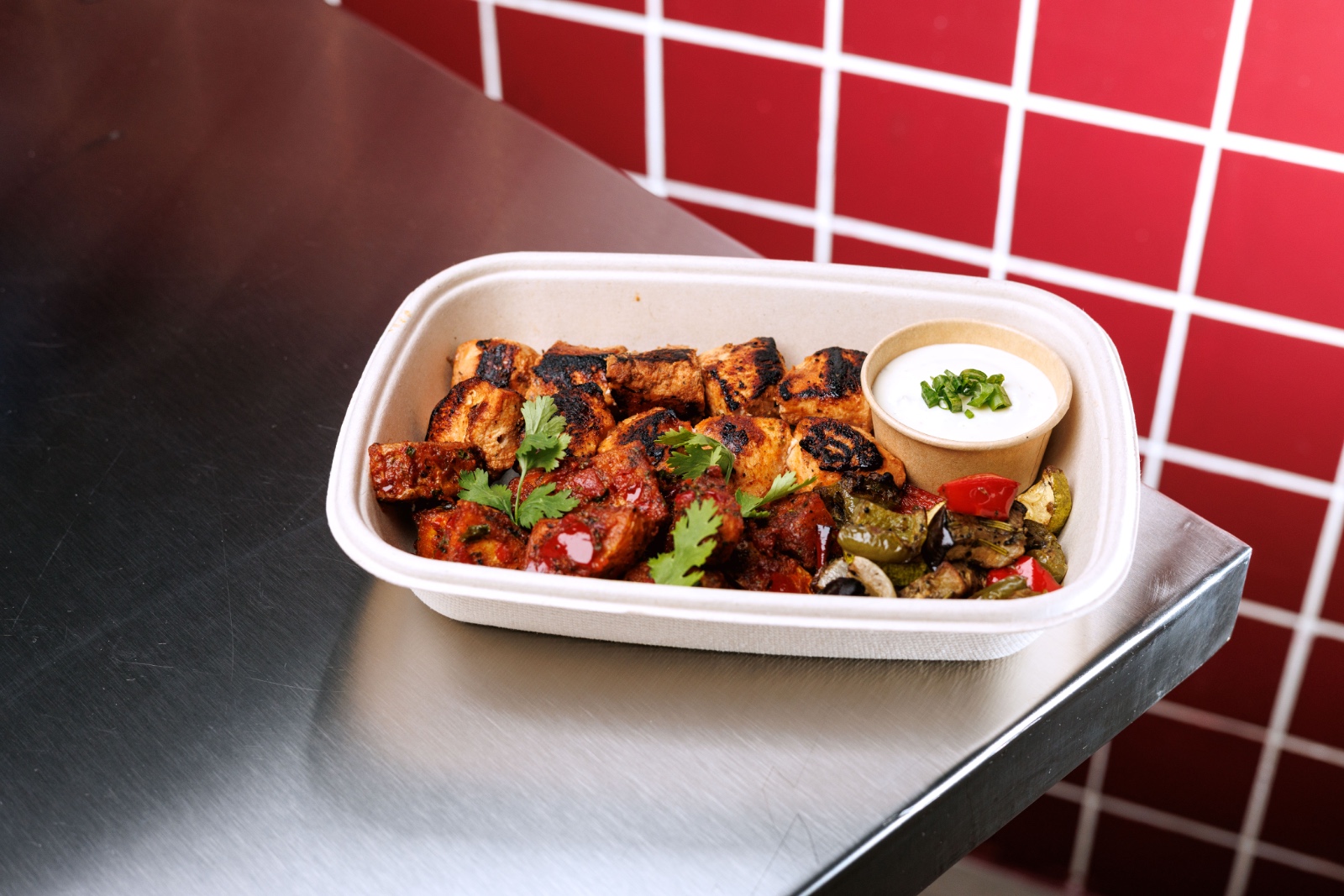 Tawook Royal — marinated grilled chicken cubes, roasted batata harra, grilled veggies, light garlic aioli